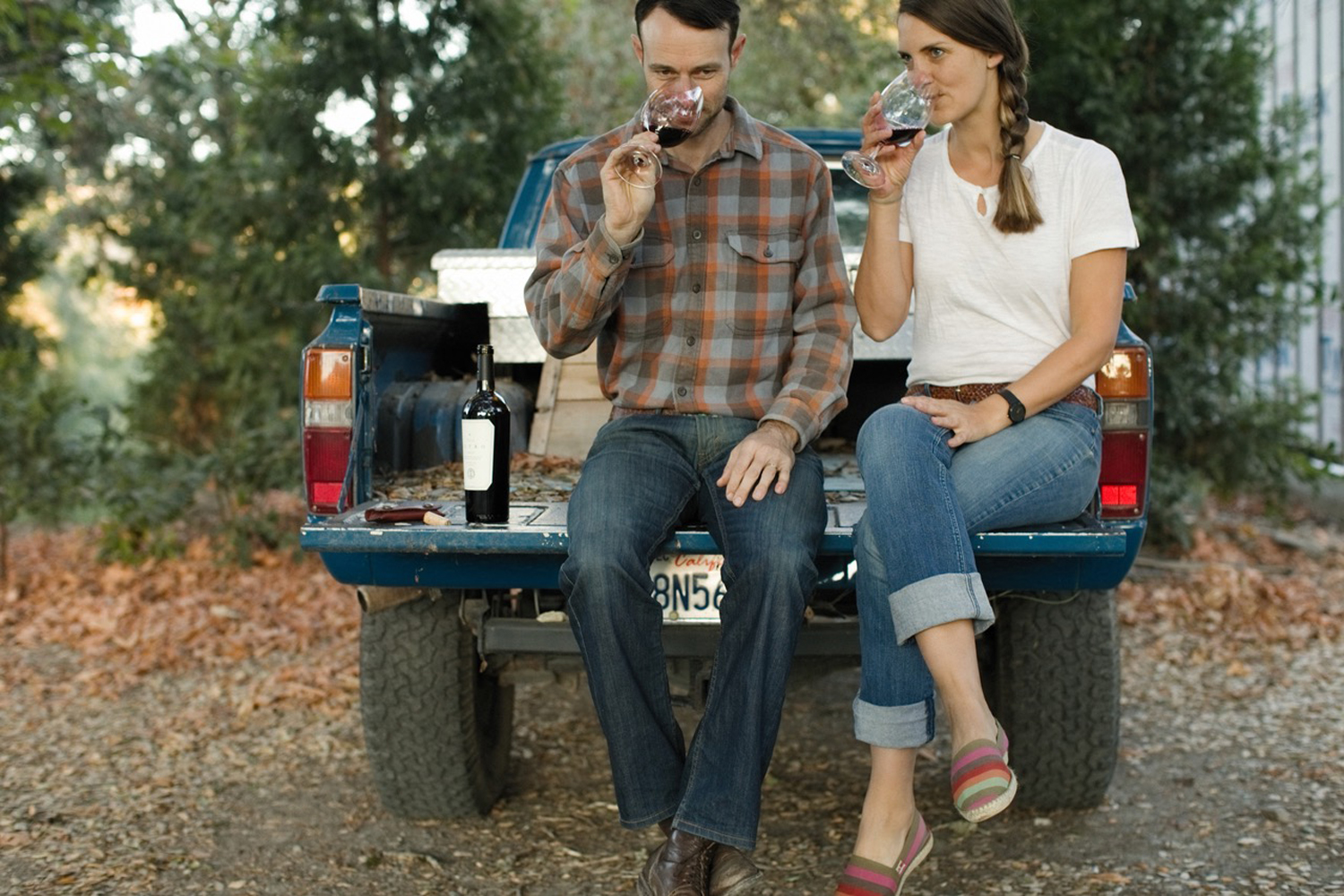 couple drinking wine, back of truck
